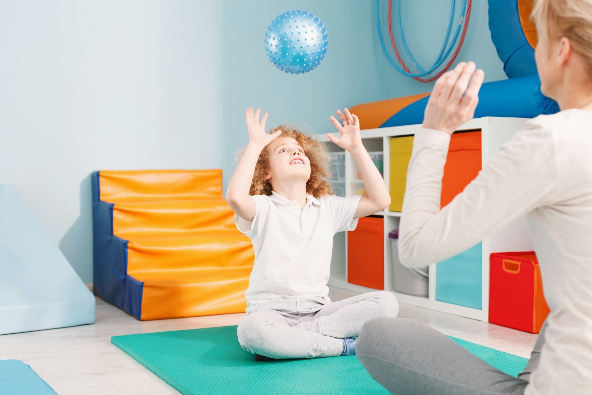 Therapist and boy playing ball